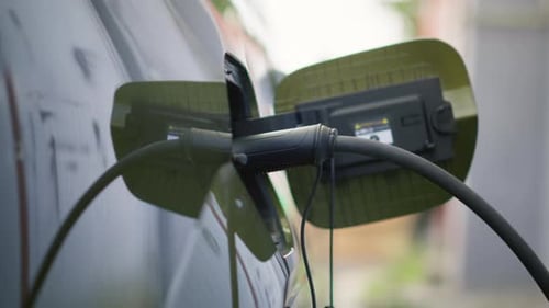 Closeup of Electric Car Charging Port Cover Opened to Recharge Depleted Battery
