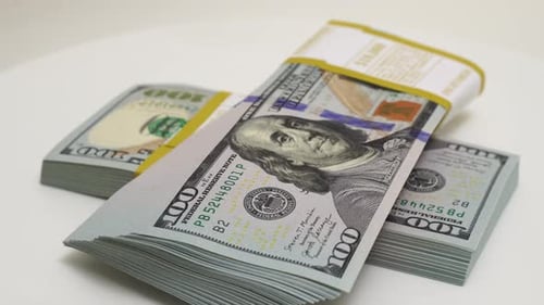 Stack of Bank Bundles with US Dollars on a White Background Closeup Shot of New Freshly Printed