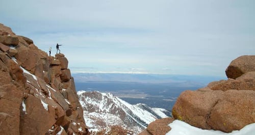 Couple on Top of Rocky Mountains, Close Up View From Peak Adventure