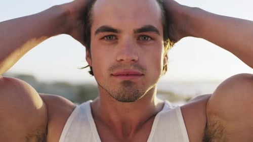 Portrait, face and smile with a man on the beach during summer for holiday or vacation in the sun