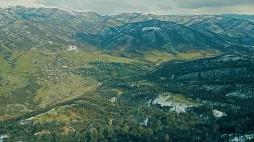 Aerial View of Rolling Hills and Mountains