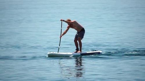 Man Sup Sea Strong Athletic Man Learns to Paddle Sup Standing on Board in Open Sea Ocean on Sunny