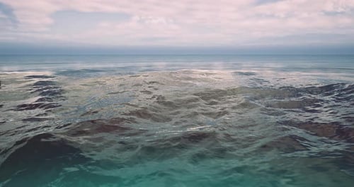Vast Ocean Waves Reflect Soft Sunlight in Tranquil Coastal Environment