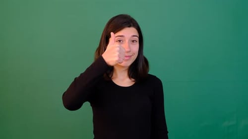 Young Woman Gives Thumbs Up on Green Screen