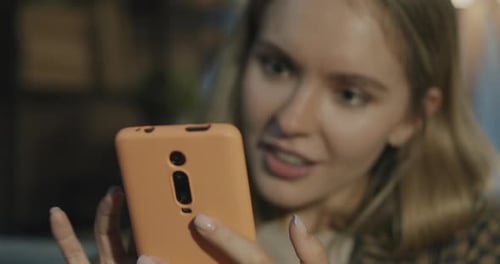 Smiling Woman Looking at Mobile Phone Close Up