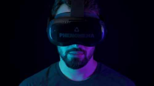 Bearded Man Wearing VR Headset in Neon Lighting