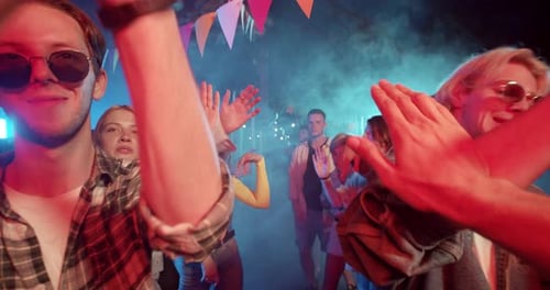 Enthusiastic Young People Dancing at an Outdoor Party