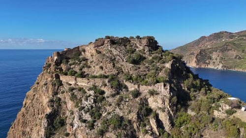 Ancient Stone Ruins on a Steep Coastal Cliff Overlooking the Sea