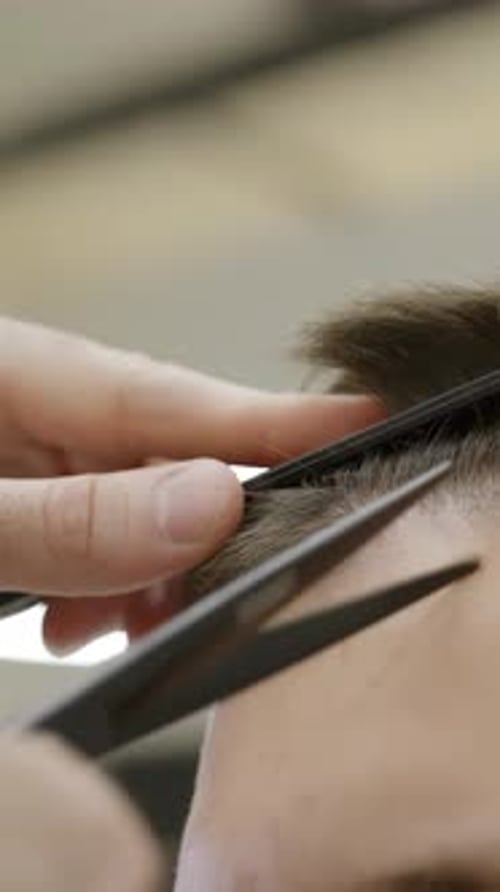 A Professional Barber Skillfully Cutting Hair Using HighPrecision Tools and Techniques Clip