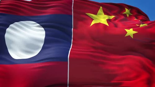 Laos and China Flags Merged Waving in the Wind