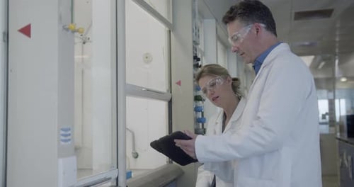Scientists Working in Lab Viewing Data on Tablet