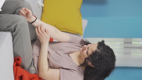 Vertical video of Young woman with itchy arms.