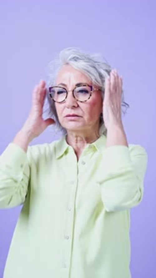 Senior Woman Experiencing Stress and Headache Indoors