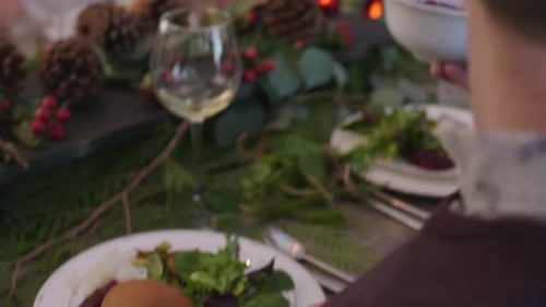 Family Having Christmas Dinner in Decorated Dining Room
