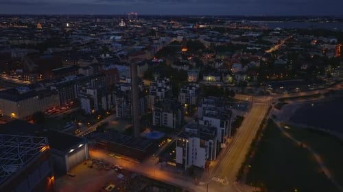 Aerial View of Evening Cityscape Forwards Fly Above Streets and Buildings in Urban Neighborhood