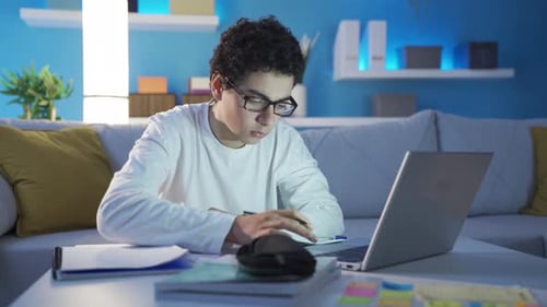 Young Adult Studying at Home with Laptop