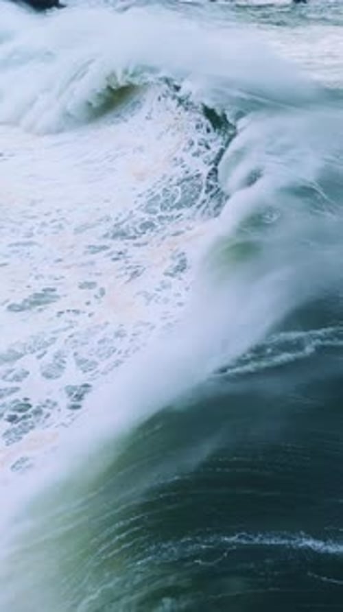 Ocean Wave Crashing with Force In Slow Motion The Emeraldgreen Water Contrasts with the Frothy White