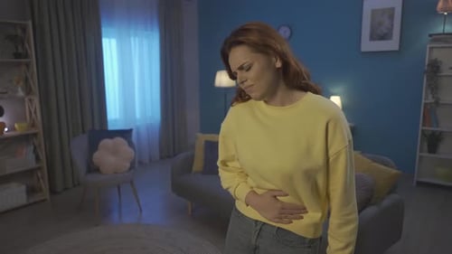 Woman Suffering from Stomach Pain in Home