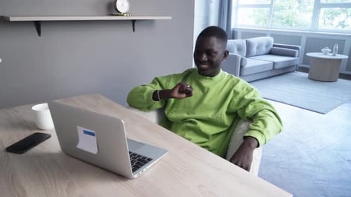 Young Man Video Conferencing on Laptop At Home