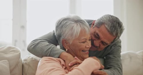 Loving Senior Couple Embracing Indoors