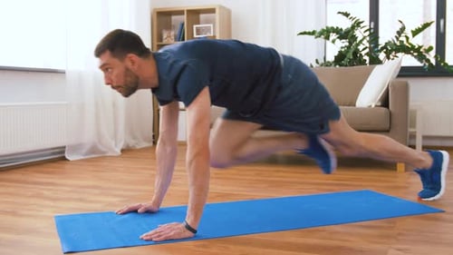 Man Doing Mountain Climber Exercise on Yoga Mat