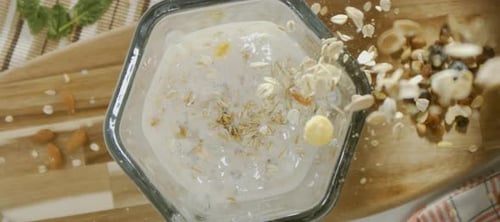 Oatmeal falling into a blender