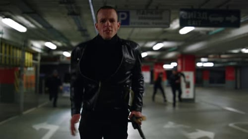 Serious Man Runs with Police in Underground Garage