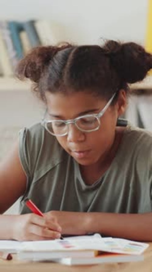 Happy Girl Doing Homework at Desk Indoors