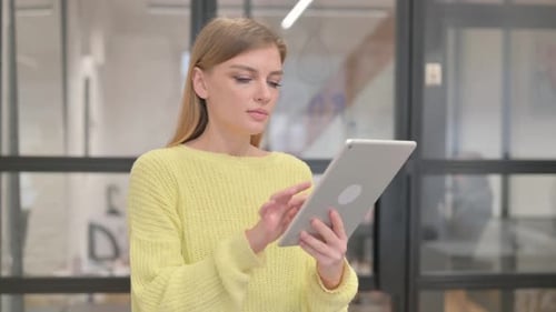 Portrait of Blonde Young Woman Using Digital Tablet