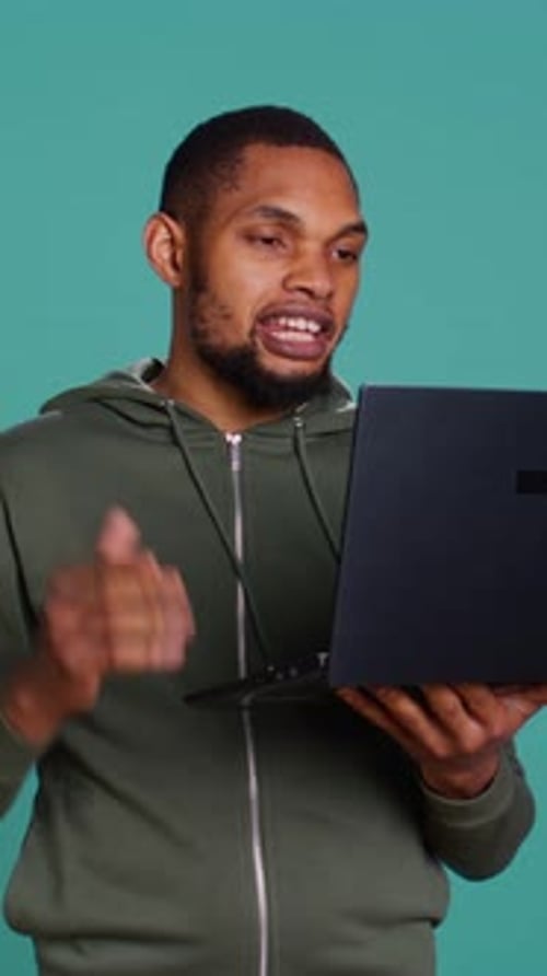 Young Adult Man Video Chatting on Laptop