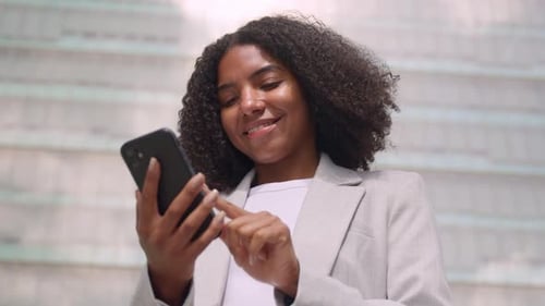 Young Busy Young African American Business Woman Using Phone in City