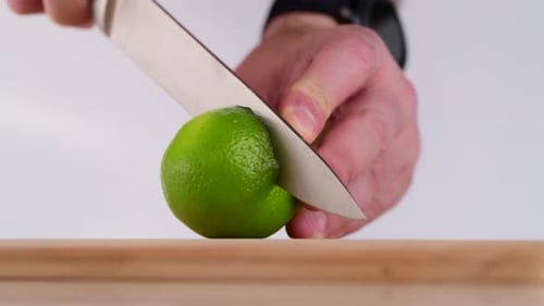 Lime Being Sliced Into Wedges on Cutting Board