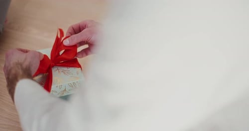 Close Up of Hands Wrapping a Christmas Present