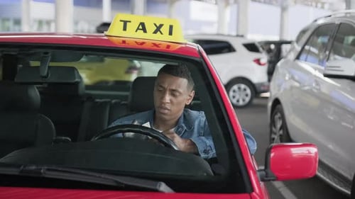 Young Adult Taxi Driver with Money in Car
