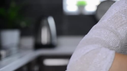 Young Woman Drinks Hot Beverage From Mug Indoors