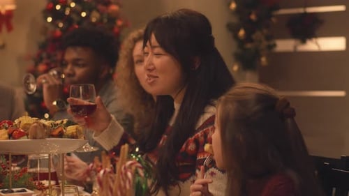 Festive Family Celebrates Christmas Dinner Together at Home