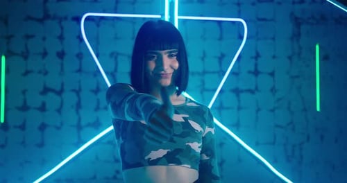 Nice Lady Shows Thumbup Sign Standing at Blue Neon Light