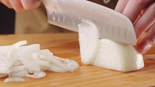 Chef Chopping a Red Onion with a Knife on the Cutting Board Macro Close Up of Cutting Red Onion on