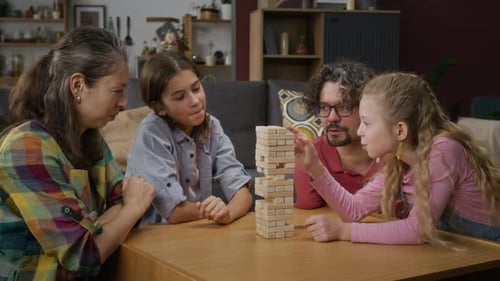 Kaukasische Familie spielt zu Hause zusammen Holzklötzenspiel