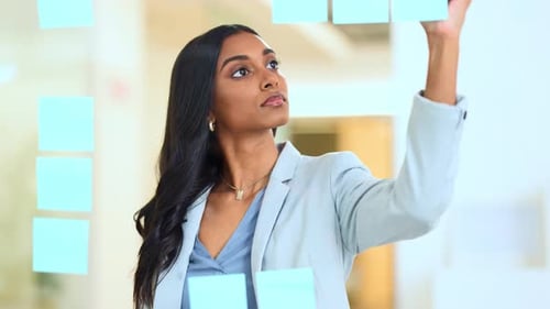 Woman Planning with Sticky Notes in Office