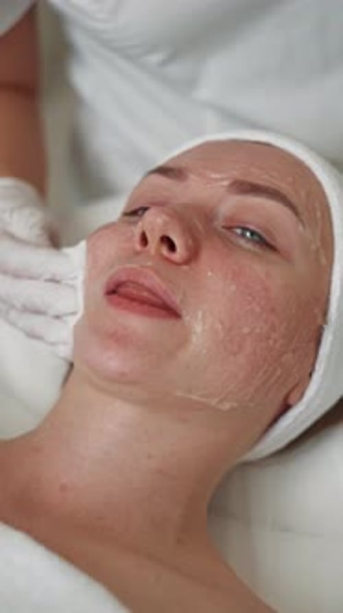 Woman Receiving Facial Treatment at Spa