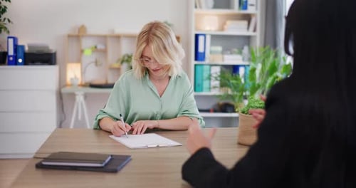 Young Woman Signs Loan Agreement