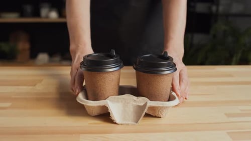Two Plastic Cups of Coffee in Holder