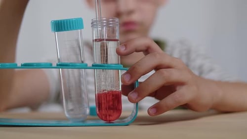 Child Doing Science Experiment With Test Tubes