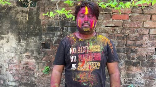 Man Covered in Colors Celebrates Holi Festival