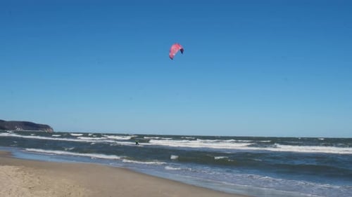 Wing Foiling Kitesurfing Wind Surfing Water Outdoor Sport in Baltic Sea Dark Blue Clouds Ocean Water