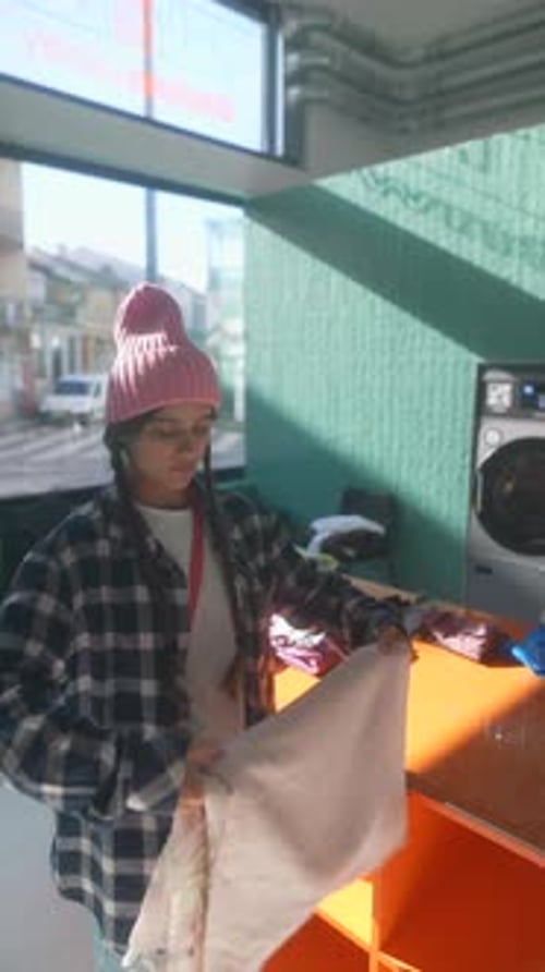 Une jeune personne créative embrassant une couverture colorée confortable dans un espace lumineux et joyeux