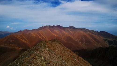 Picturesque Aerial Landscape With Mountains In Autumn Day Drone Flying on Top Of Mount With Person