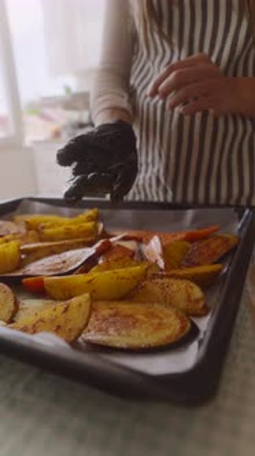 Preparing Freshly Baked Potatoes in Kitchen