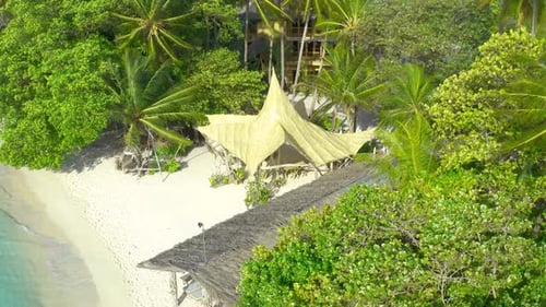 Aerial Top View on White Sand Beach with Thatched Huts and Lush Tropical Island Bora Bora French